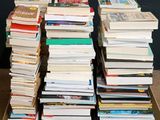 many books stacked on top of each other in a box