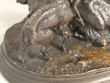 a bronze statue of a man riding a horse and a dog