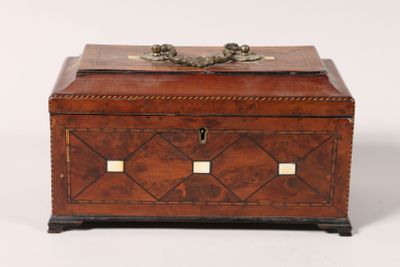 an antique wooden box with two lions on top of it