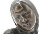 a bronze statue of a woman with braids on her head