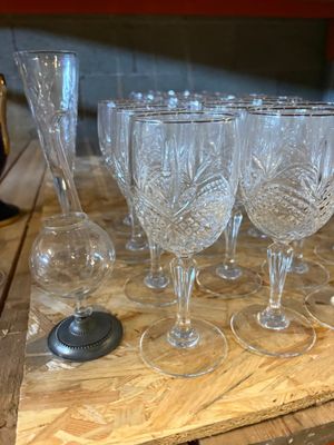 a lot of wine glasses sitting on a wooden table