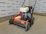 an image of a small lawn mower parked in a garage