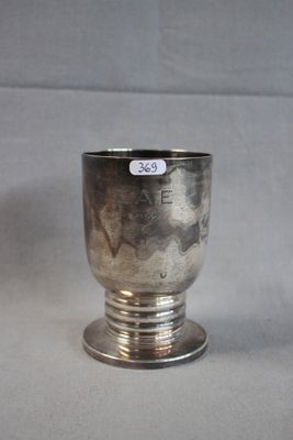 a silver cup that is sitting on a table