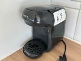 a coffee maker that is sitting on the floor