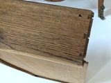 a small wooden box sitting on a table next to a dresser
