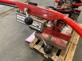 a red machine that is sitting on a pallet