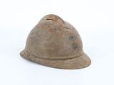 an old helmet that is sitting on the ground