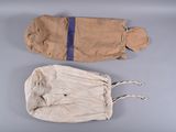 two bags of cloth are sitting on a gray surface