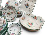 many plates and bowls that are sitting on a white surface