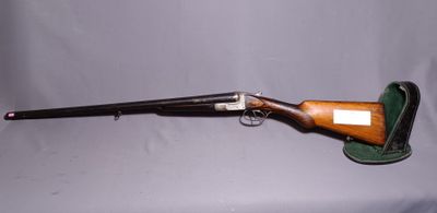 an old rifle with a wooden barrel and a leather case