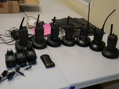 many cell phones and other electronic devices on a table