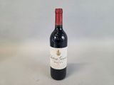 the bottle of red wine is sitting on the table