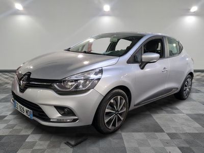 a silver car is parked on a checkered floor in a garage