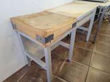 a wooden table with a laptop on top of it