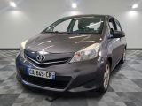 the toyota yaris is parked on a checkered floor in a garage