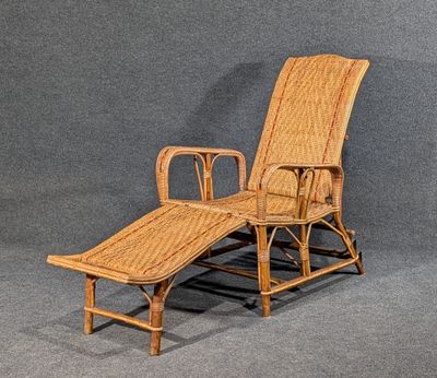 une image représentant une chaise longue en osier sur fond gris