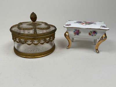 two pieces of porcelain and gold - plated furniture on a white surface