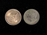 two coins are shown side by side on a black surface
