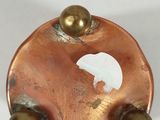 an image of a close up of a metal object on a white surface