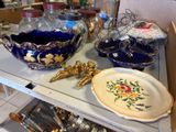 a shelf that has many different types of dishes on it