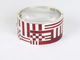 silver ring with red and white squares on it