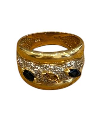 an image of a gold ring with black stones on a white background