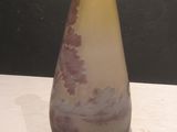 a vase that is sitting on a table in front of a black wall