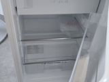 an open refrigerator that is sitting on the floor