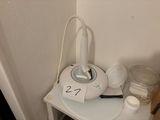 a small white table with a cup on top of it