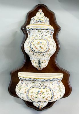 a wall mounted shelf with two vases on it
