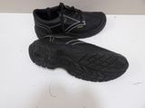 a pair of black shoes that are on a table