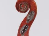 a close up of a violin neck with a fiddle in the background