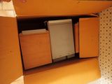 a box with a refrigerator inside of it on the floor