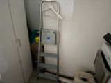 a ladder that is leaning against a wall in a room