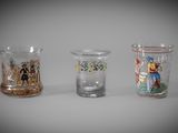 three different colored glass vases sitting next to each other on a table