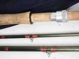 two different types of fishing rods laying on a table