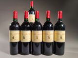 six bottles of wine are lined up on a table