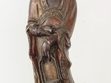 an antique bronze statue of a woman holding a basket