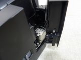 a close up picture of a black television with a remote in it
