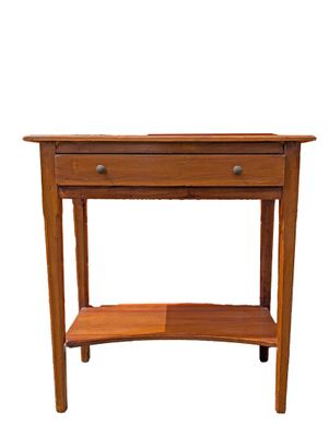 a small wooden table with a shelf underneath it