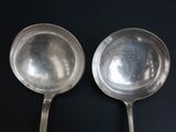 two spoons that are sitting on a table