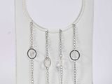 white leather purse with silver chains hanging from it ' s handle