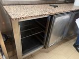 a stainless steel counter top with a microwave on it