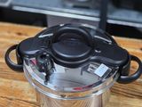 a pot with a lid on a wooden table