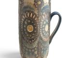 a blue and white pitcher with a pattern on it