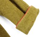 an image of a close up of a green coat with red pips