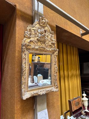 a mirror hanging on the wall next to a table