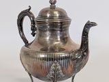 silver plated teapot with peacock decoration on stand