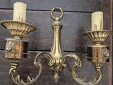 three candles that are on the wall next to each other