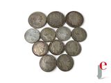 a lot of coins that are on a white surface